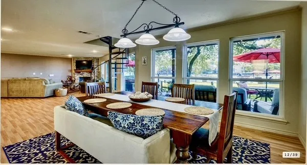 a dining room with furniture a rug and a large window