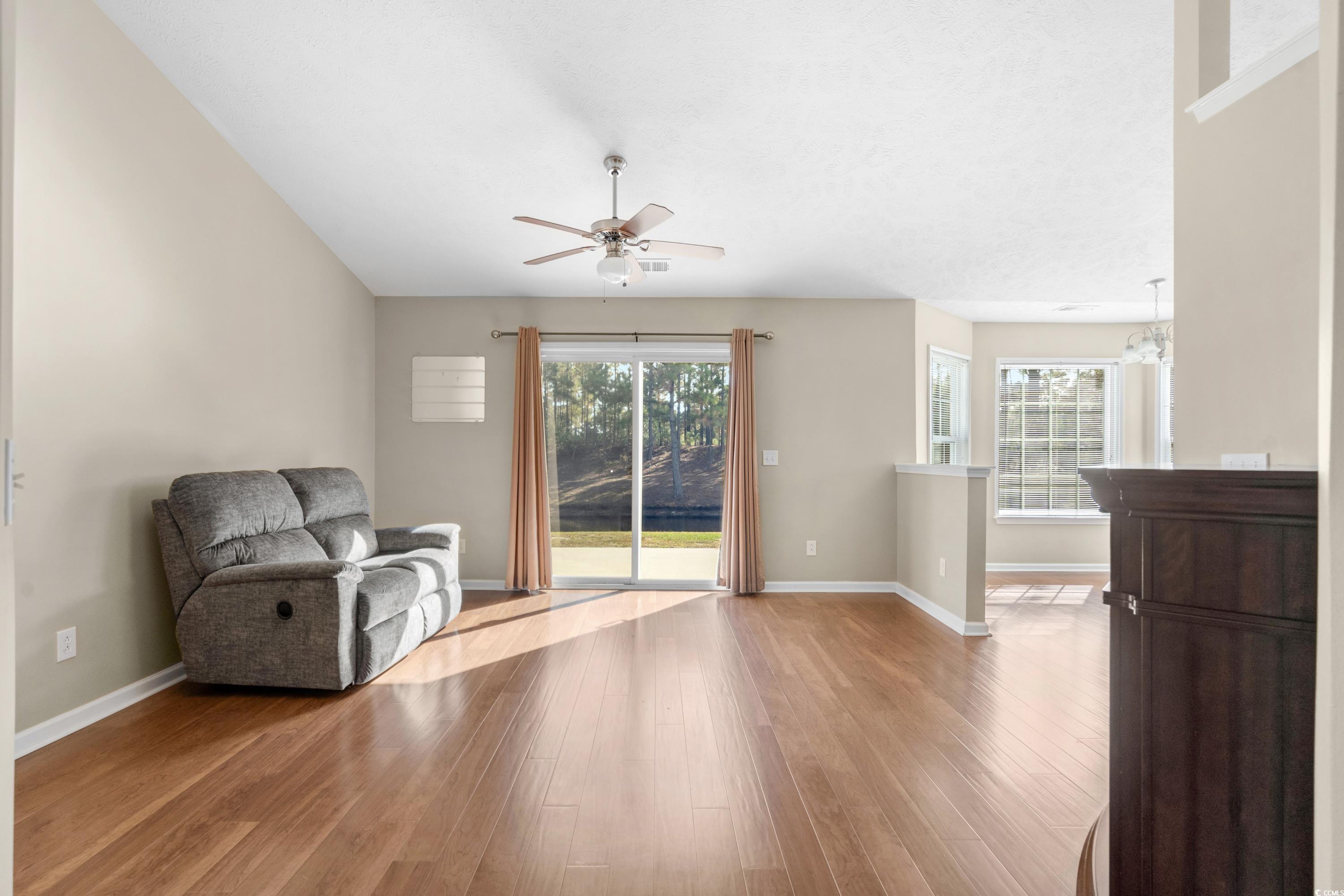 4659 East Walkerton Road Myrtle Beach, SC 29579 - Photo 8 of 40 Living area with ceiling fan with notable chandeli