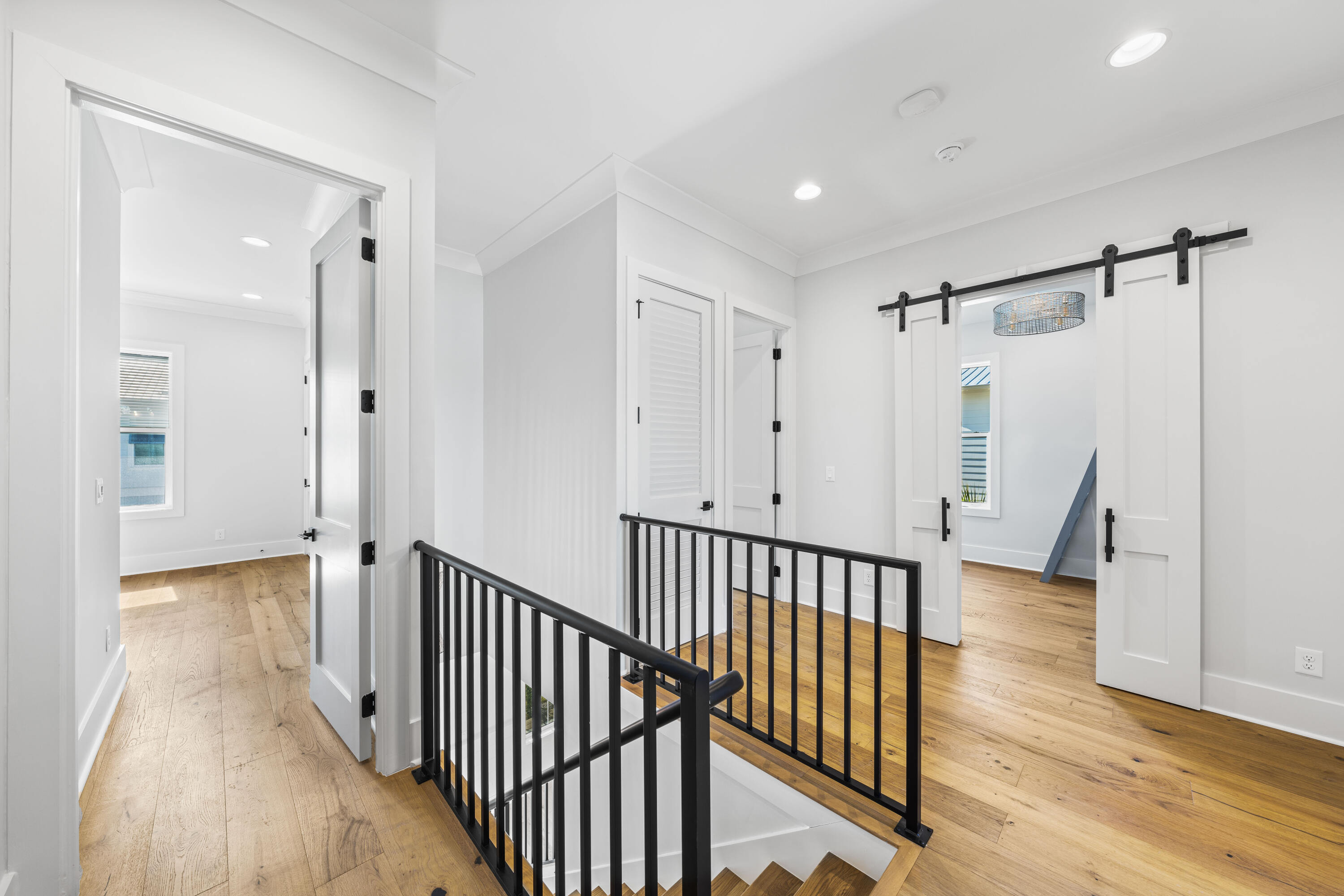 20 Casa Breeze Lane, Unit 20B Santa Rosa Beach, FL 32459 - Photo 20 of 41 a view of a hallway with wooden floor and staircase