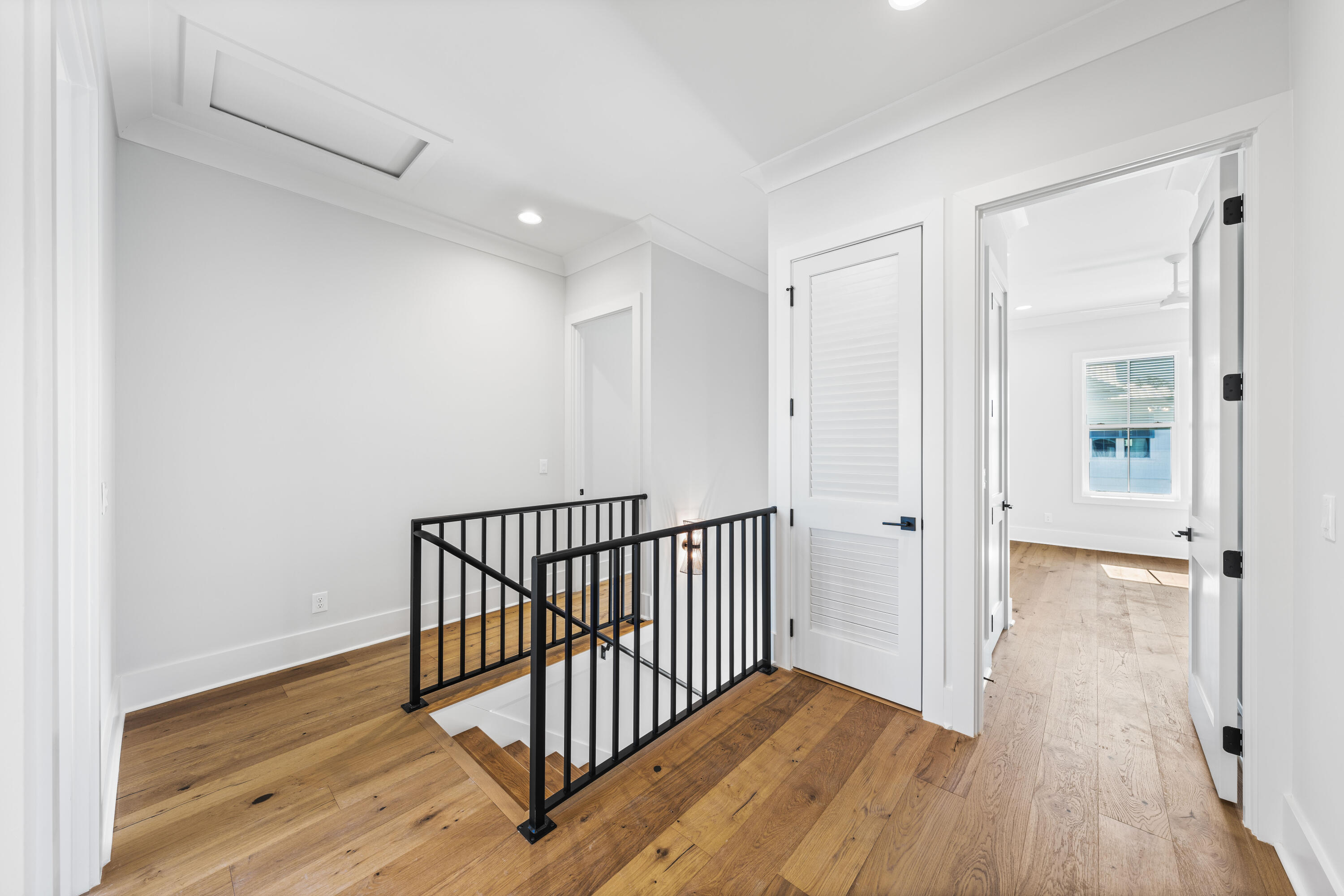 20 Casa Breeze Lane, Unit 20B Santa Rosa Beach, FL 32459 - Photo 28 of 41 a view of a hallway with wooden floor and a bathroom