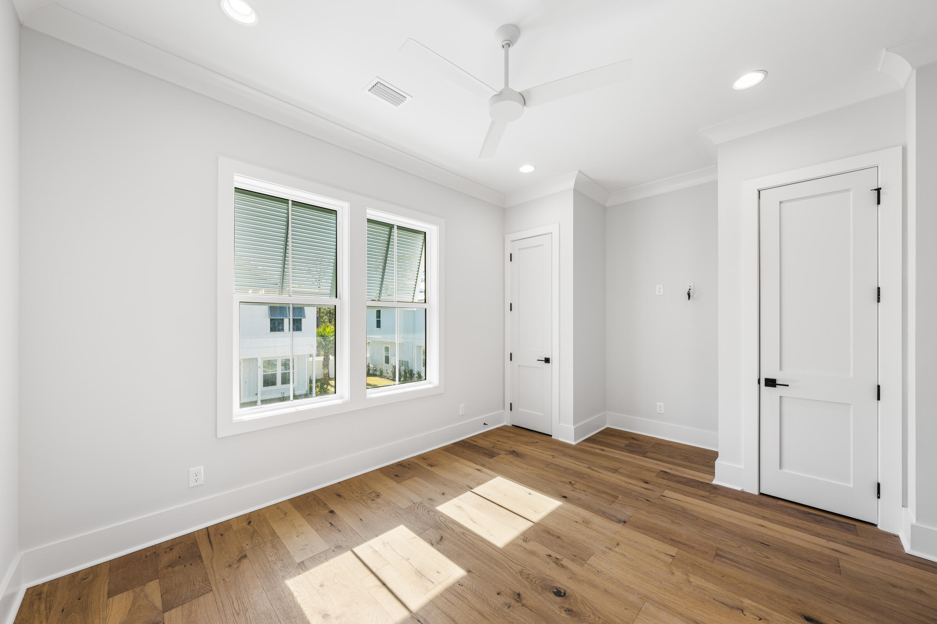 20 Casa Breeze Lane, Unit 20B Santa Rosa Beach, FL 32459 - Photo 35 of 41 a view of empty room with wooden floor and fan