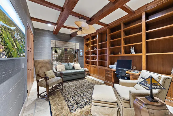 a bedroom with a bed a chandelier and a dresser