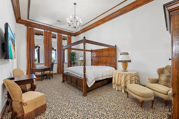 a bedroom with furniture and a large window