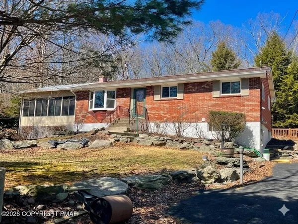 a front view of house with yard and lake view