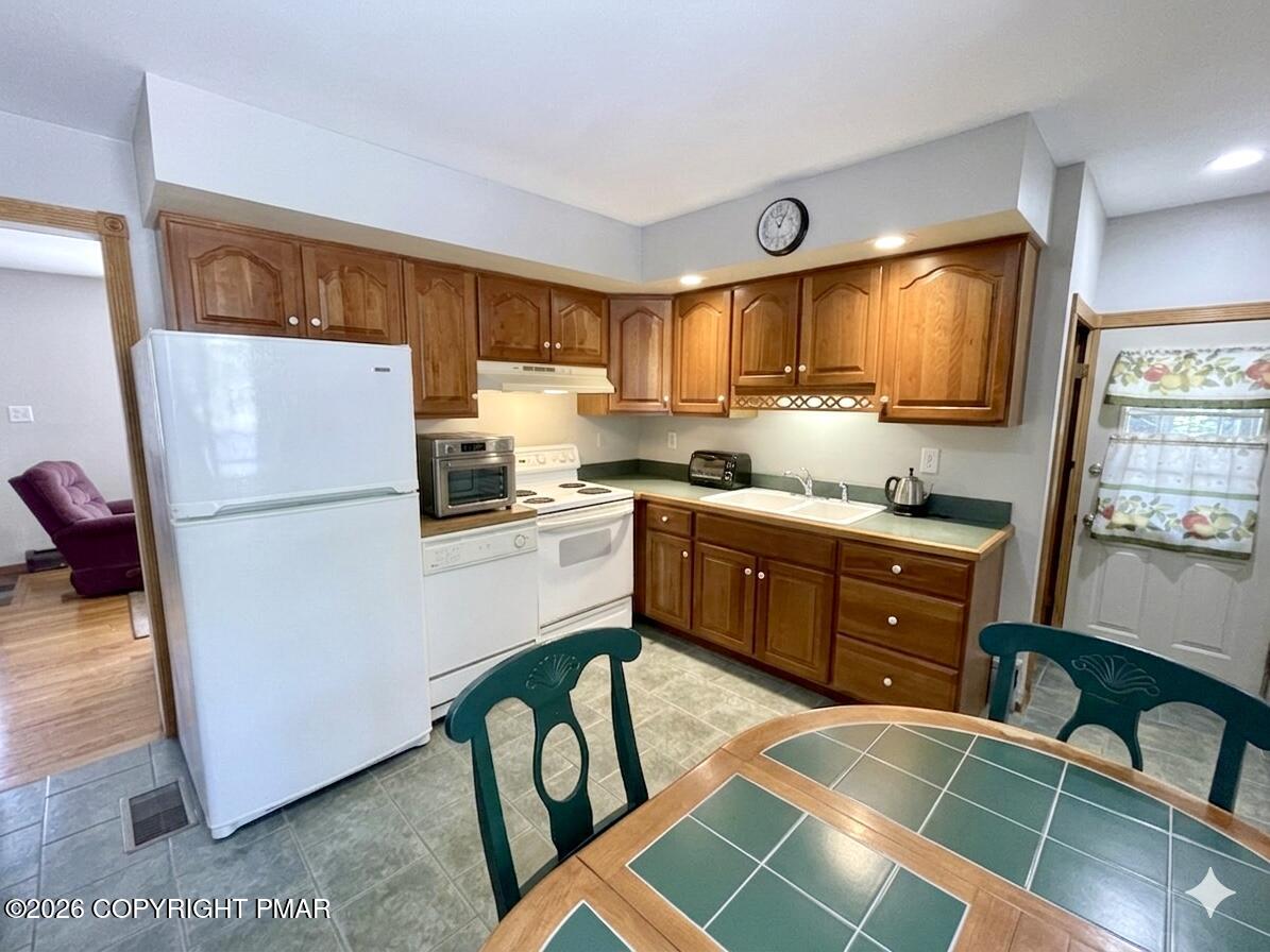 2319 Bear Town Road Canadensis, PA 18325 - Photo 11 of 31 a kitchen with a refrigerator and a stove top oven