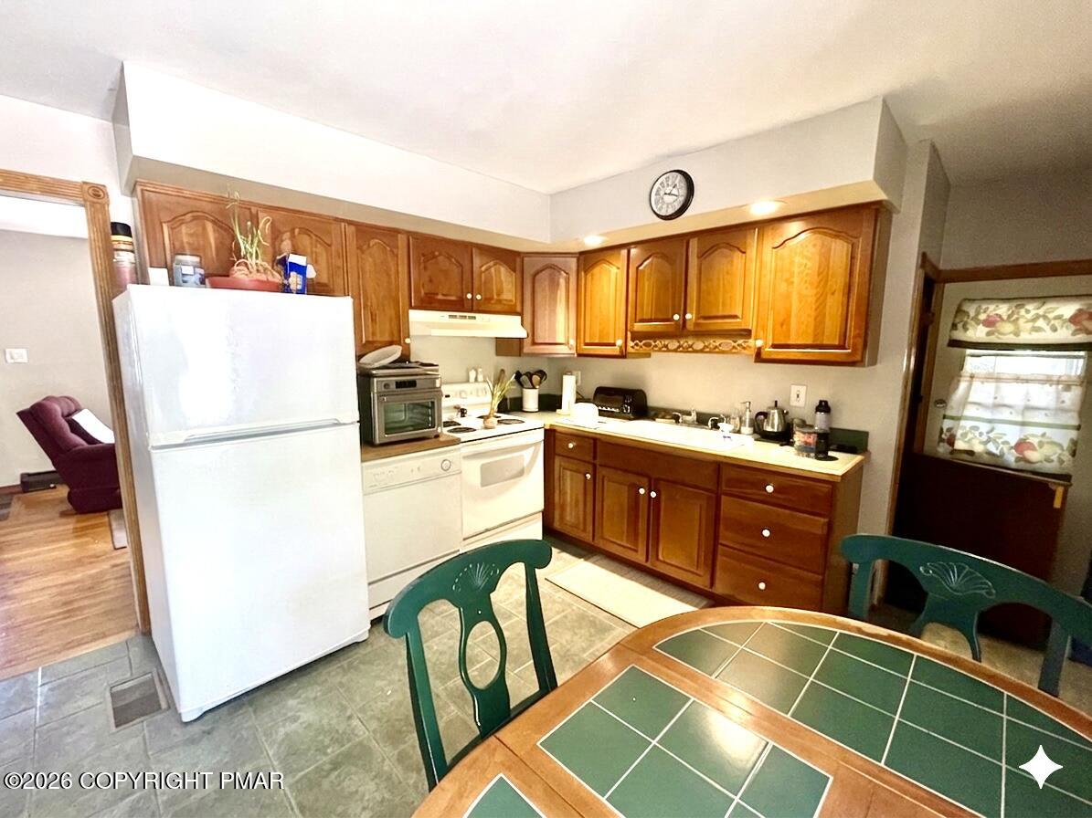 2319 Bear Town Road Canadensis, PA 18325 - Photo 12 of 31 a kitchen with stainless steel appliances granite countertop a refrigerator and a stove top oven