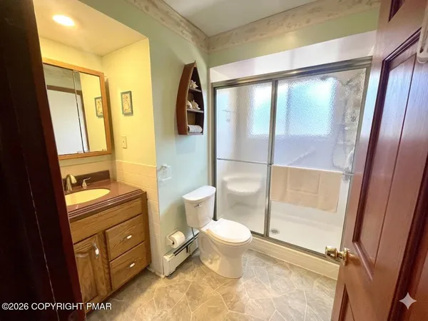 a bathroom with a granite countertop sink toilet and shower