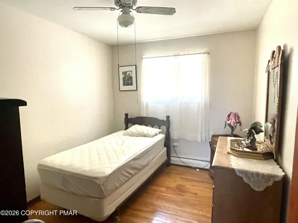 a bedroom with a bed and a dresser