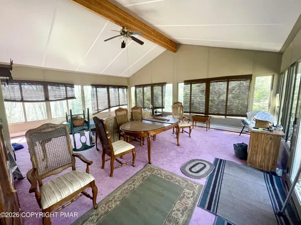 a living room with furniture and a floor to ceiling window