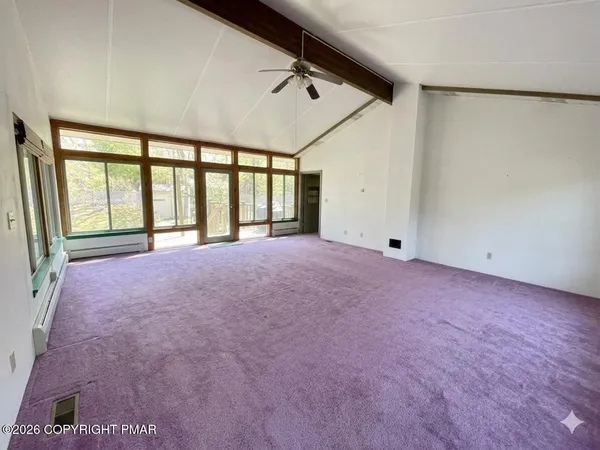 a view of an empty room with a balcony