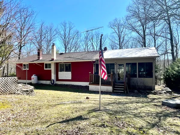 a view of a house with a yard covered in snow