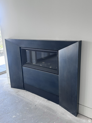 1918 Chimney Rock Road Heber City, UT 84032 - Photo 50 of 74 Modern built-in fireplace with a dark metal surround, glass screen, and decorative stones