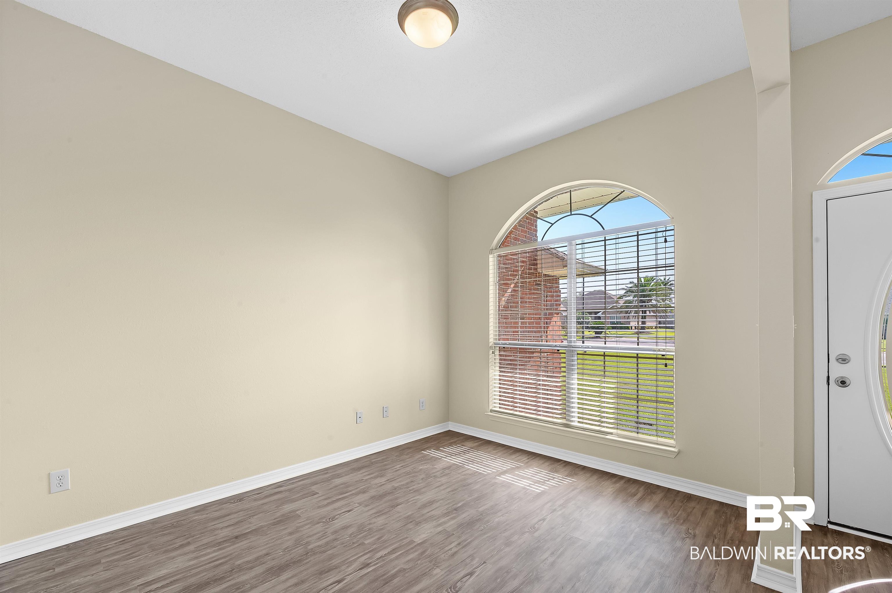 12443 Venice Boulevard Foley, AL 36535 - Photo 18 of 59 Interior space featuring a healthy amount of sunlight and hardwood / wood-style flooring