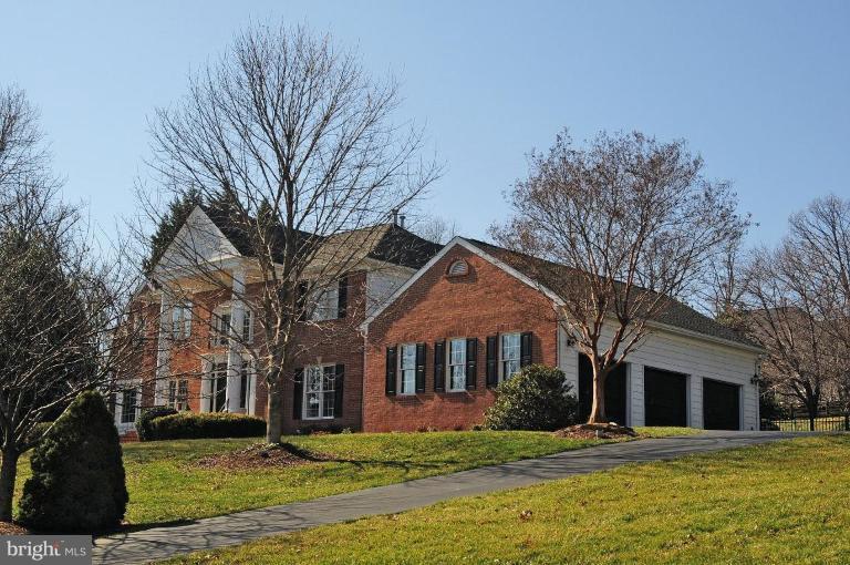 1214 Tottenham Court Reston, VA 20194 - Photo 1 of 13 a front view of a house with a yard