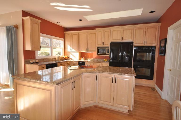 1214 Tottenham Court Reston, VA 20194 - Photo 2 of 13 a kitchen with stainless steel appliances granite countertop a refrigerator and a sink