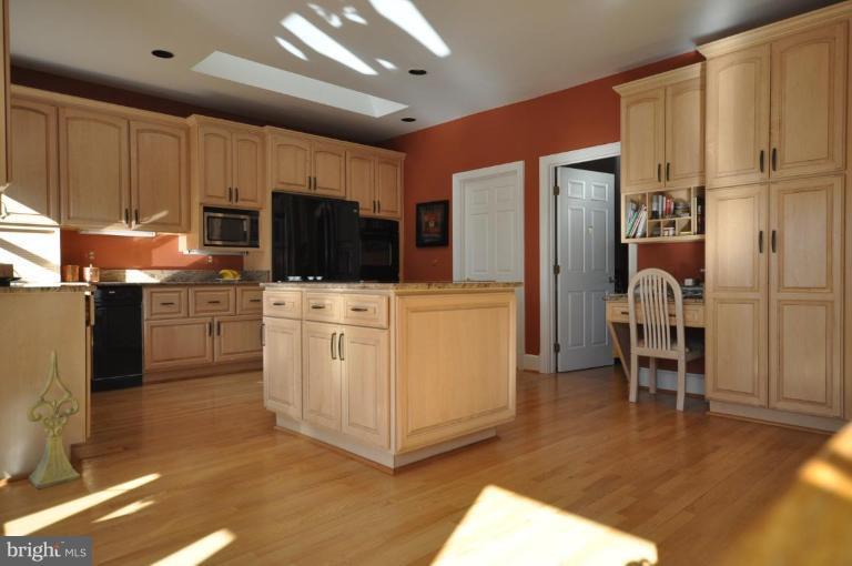 1214 Tottenham Court Reston, VA 20194 - Photo 4 of 13 a kitchen with white cabinets and stainless steel appliances