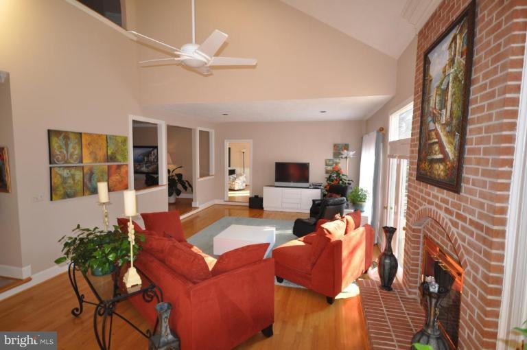 1214 Tottenham Court Reston, VA 20194 - Photo 7 of 13 a living room with furniture a flat screen tv and a fireplace