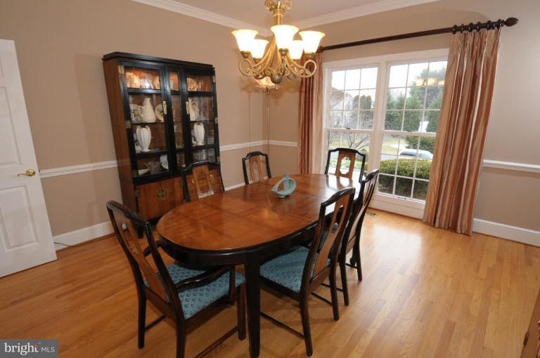 1214 Tottenham Court Reston, VA 20194 - Photo 9 of 13 a dining room with furniture a chandelier and wooden floor