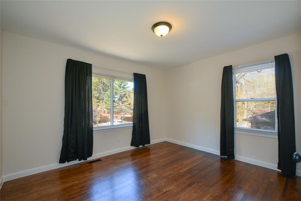 554 Alpine Way Marietta, GA 30062 - Photo 17 of 27 an empty room with wooden floor and windows