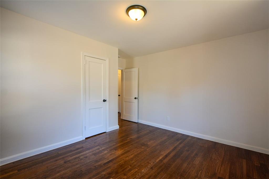 554 Alpine Way Marietta, GA 30062 - Photo 19 of 27 a view of an empty room with wooden floor and a window