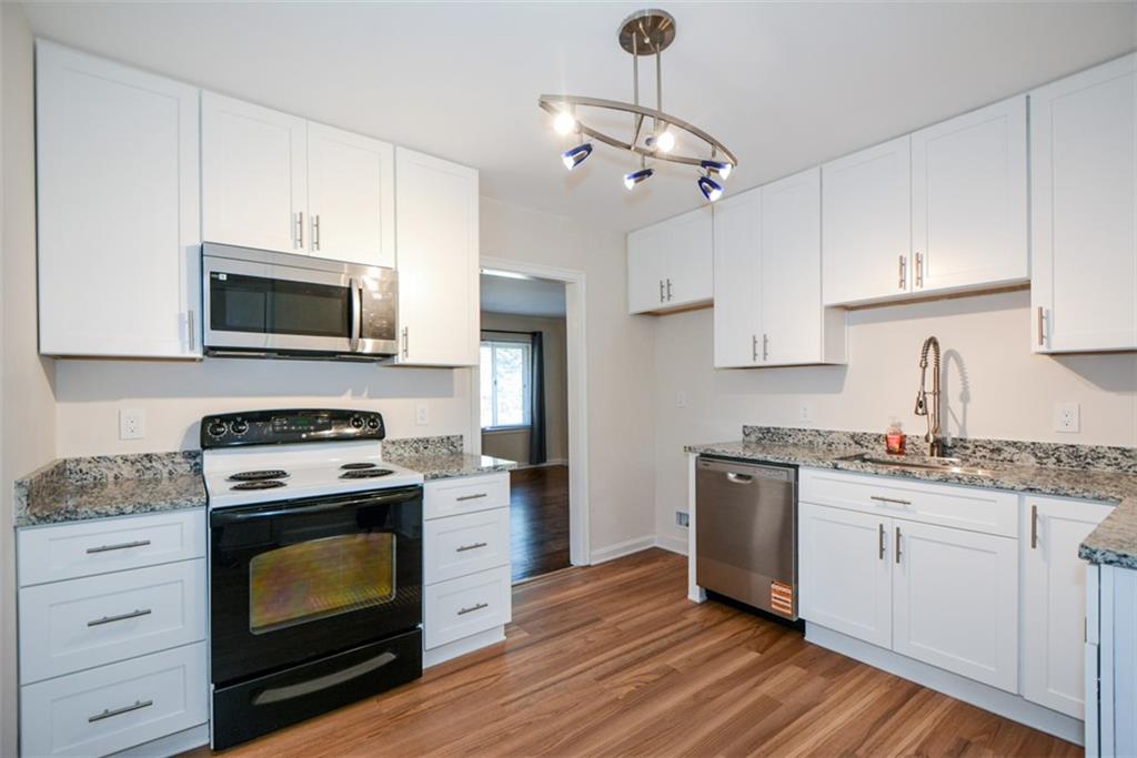 554 Alpine Way Marietta, GA 30062 - Photo 8 of 27 a kitchen with stainless steel appliances granite countertop a stove top oven a sink dishwasher and a refrigerator