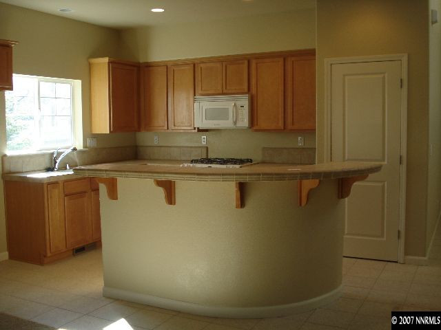 3290 Paragon Place Reno, NV 89509 - Photo 3 of 8 a view of a sink a window and cabinets