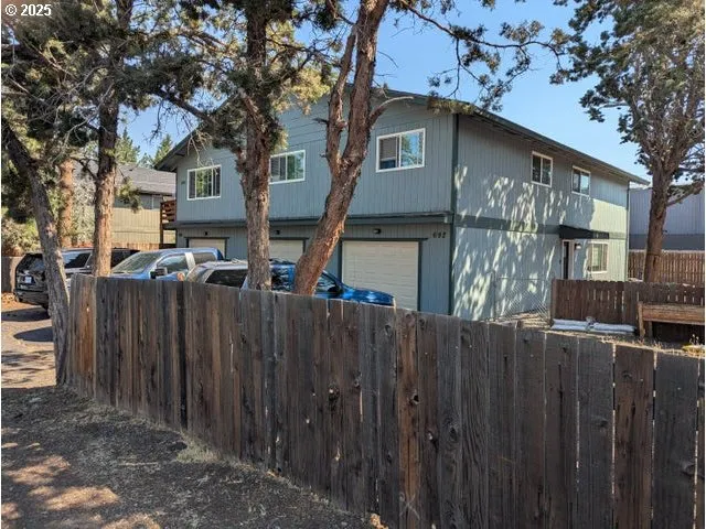 a front view of a house with a wooden fence