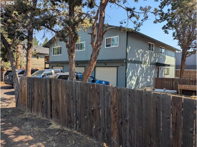 688 Southeast Centennial Street Bend, OR 97702 - Photo 1 of 1 a front view of a house with a wooden fence