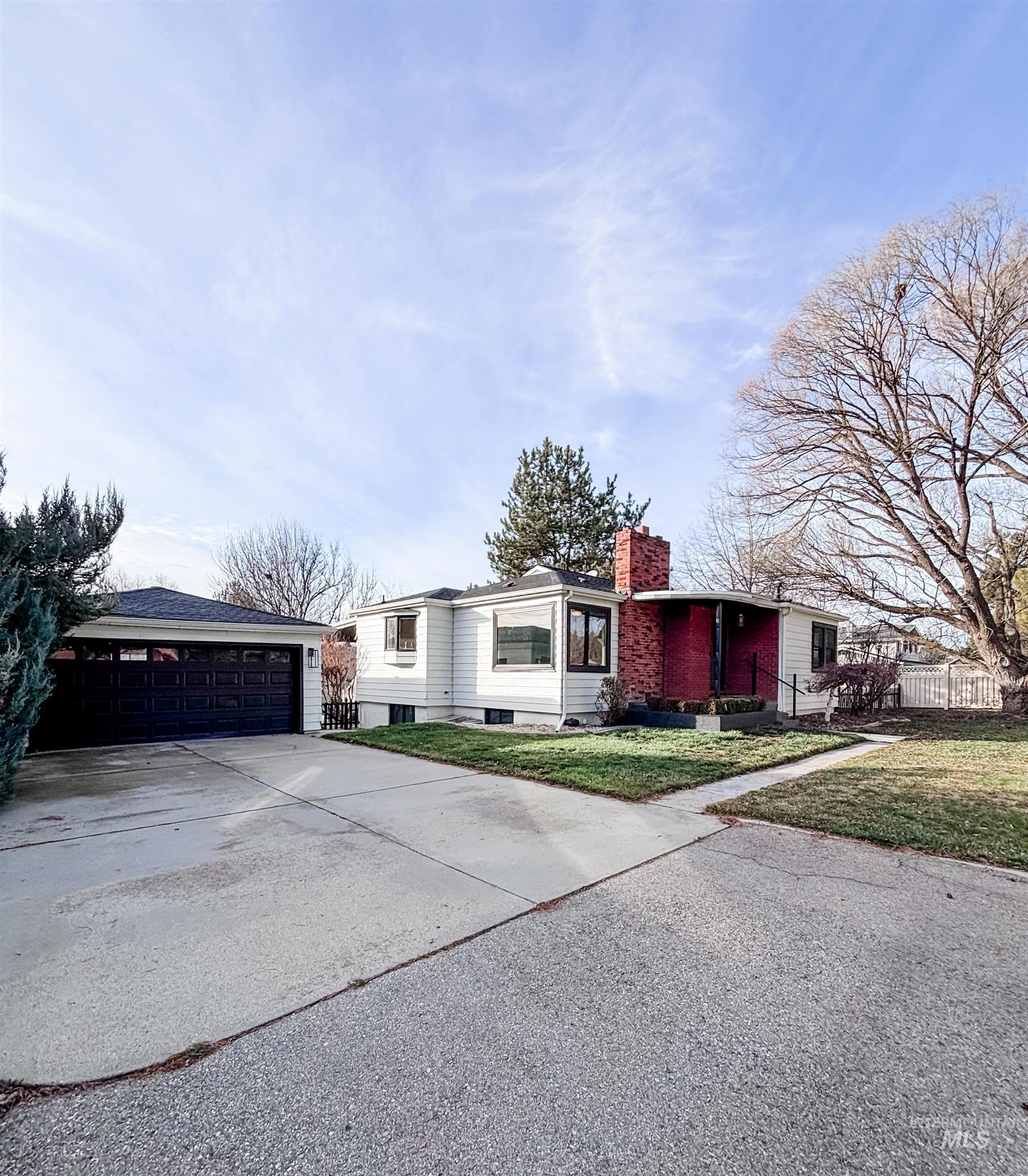 743 North Horseshoe Bend Road Eagle, ID 83616 - Photo 1 of 27 Ranch-style home featuring a chimney and a garage