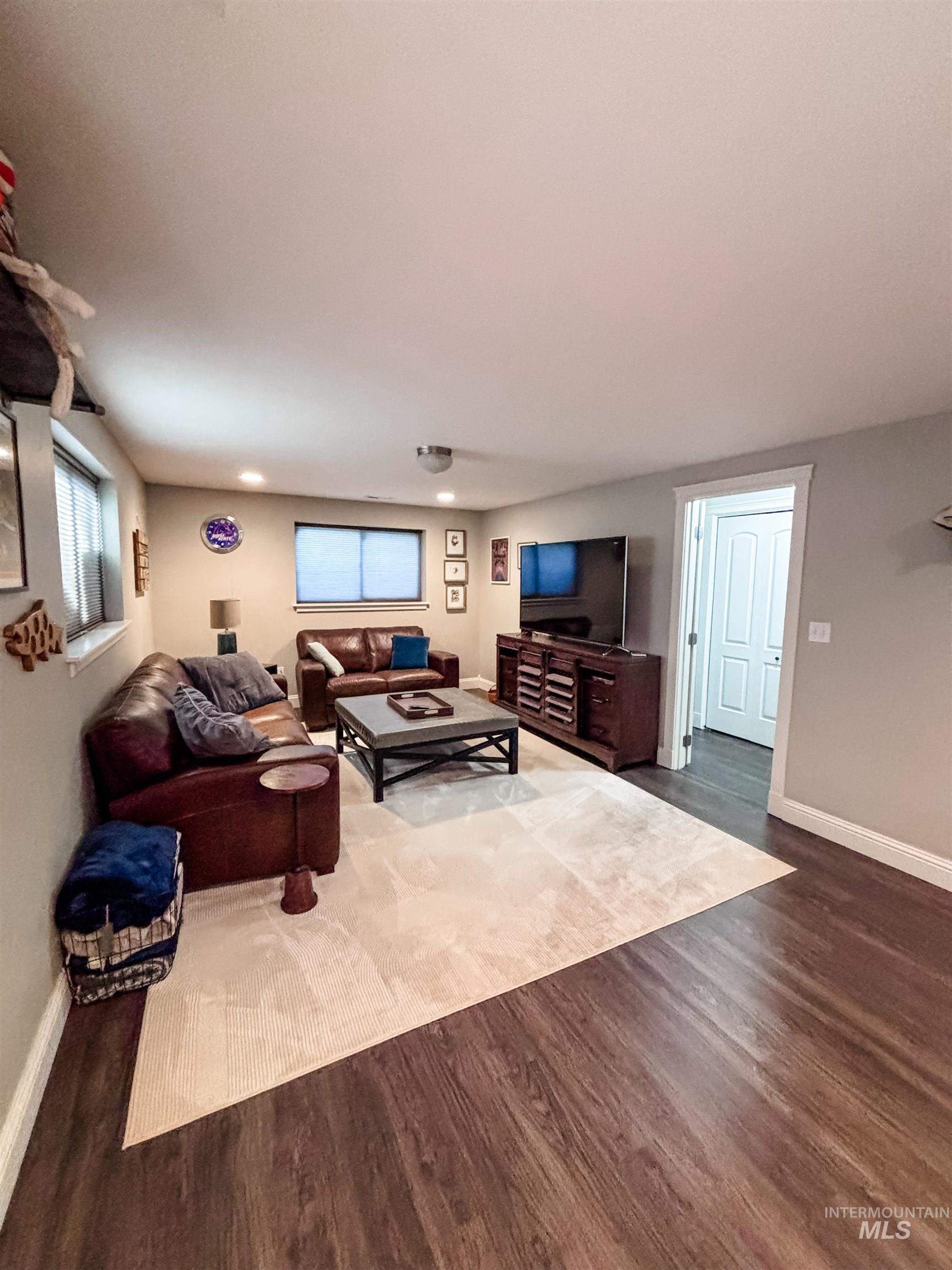 743 North Horseshoe Bend Road Eagle, ID 83616 - Photo 11 of 27 Living room with dark wood finished floors and healthy amount of natural light