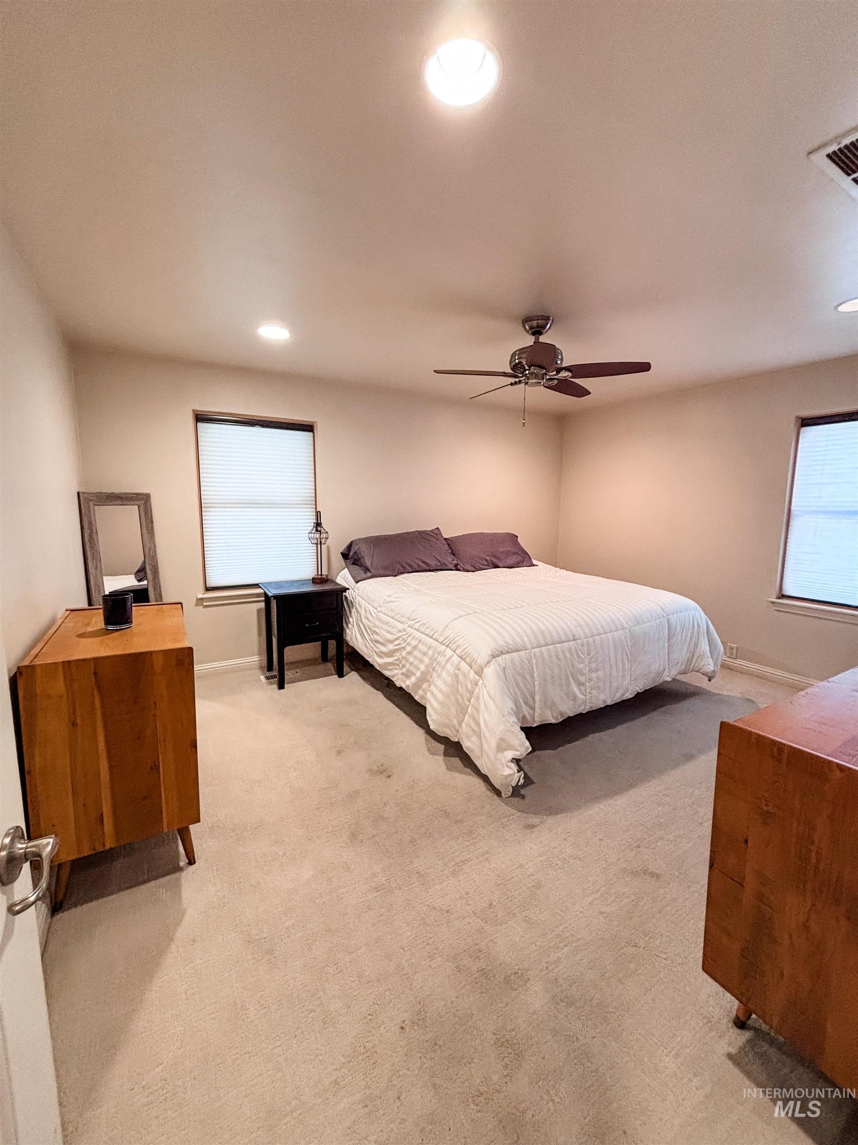 743 North Horseshoe Bend Road Eagle, ID 83616 - Photo 12 of 27 Bedroom featuring light carpet, recessed lighting, and a ceiling fan