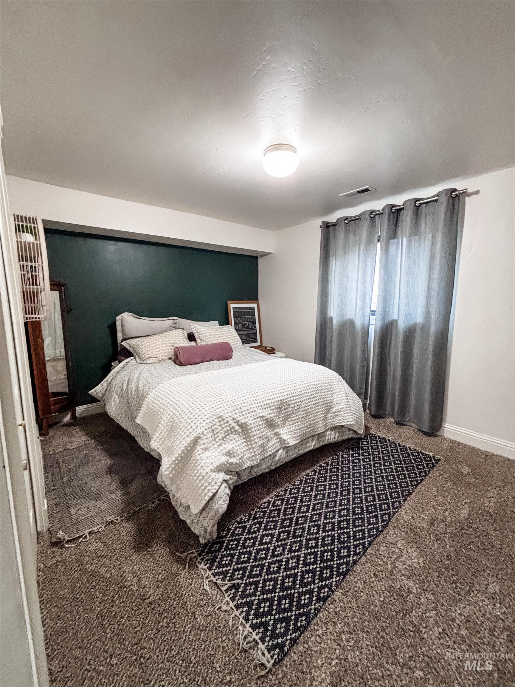 743 North Horseshoe Bend Road Eagle, ID 83616 - Photo 13 of 27 Carpeted bedroom featuring baseboards and a textured ceiling