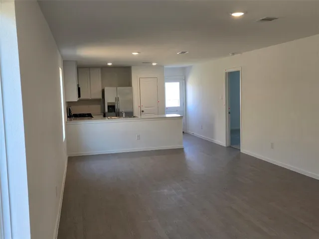 a view of a kitchen with a sink and a refrigerator