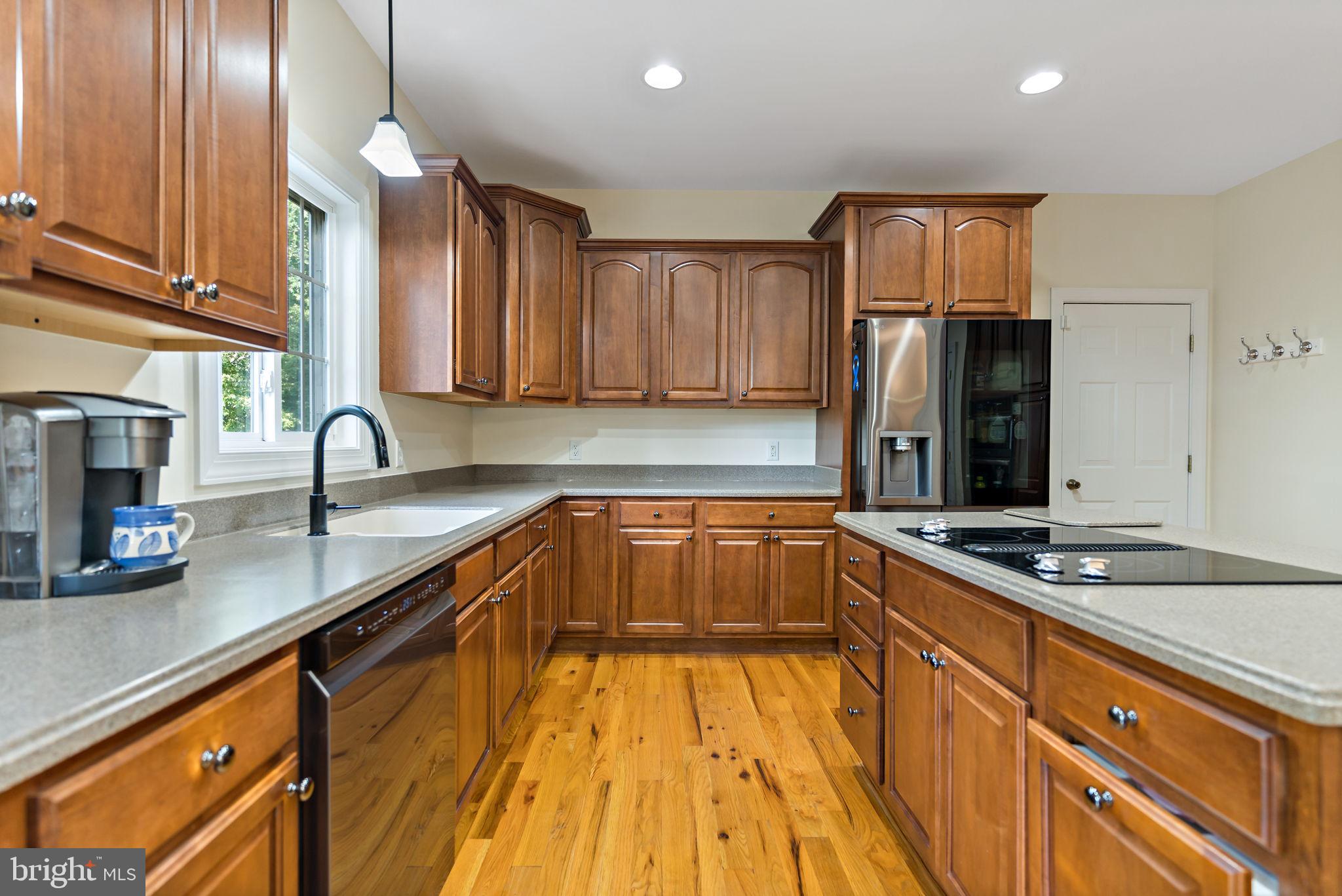 33 Caesar Road Harpers Ferry, WV 25425 - Photo 13 of 47 a kitchen with granite countertop a sink and a stove top oven with wooden floor