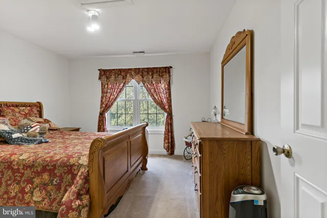 a bed room with a bed and a window