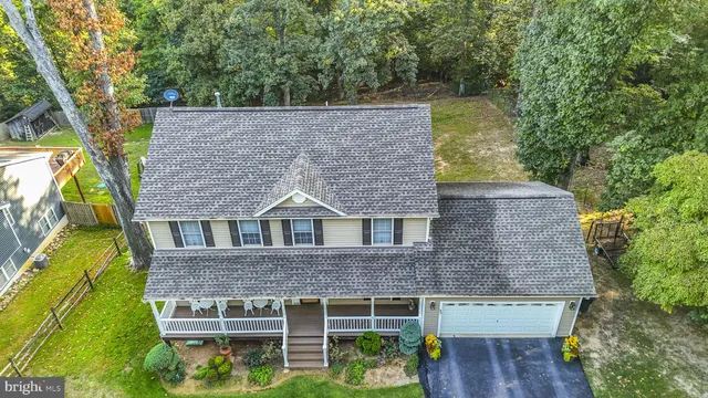 aerial view of a house with a yard