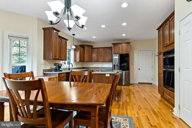 a view of a dining room with furniture and a chandelier
