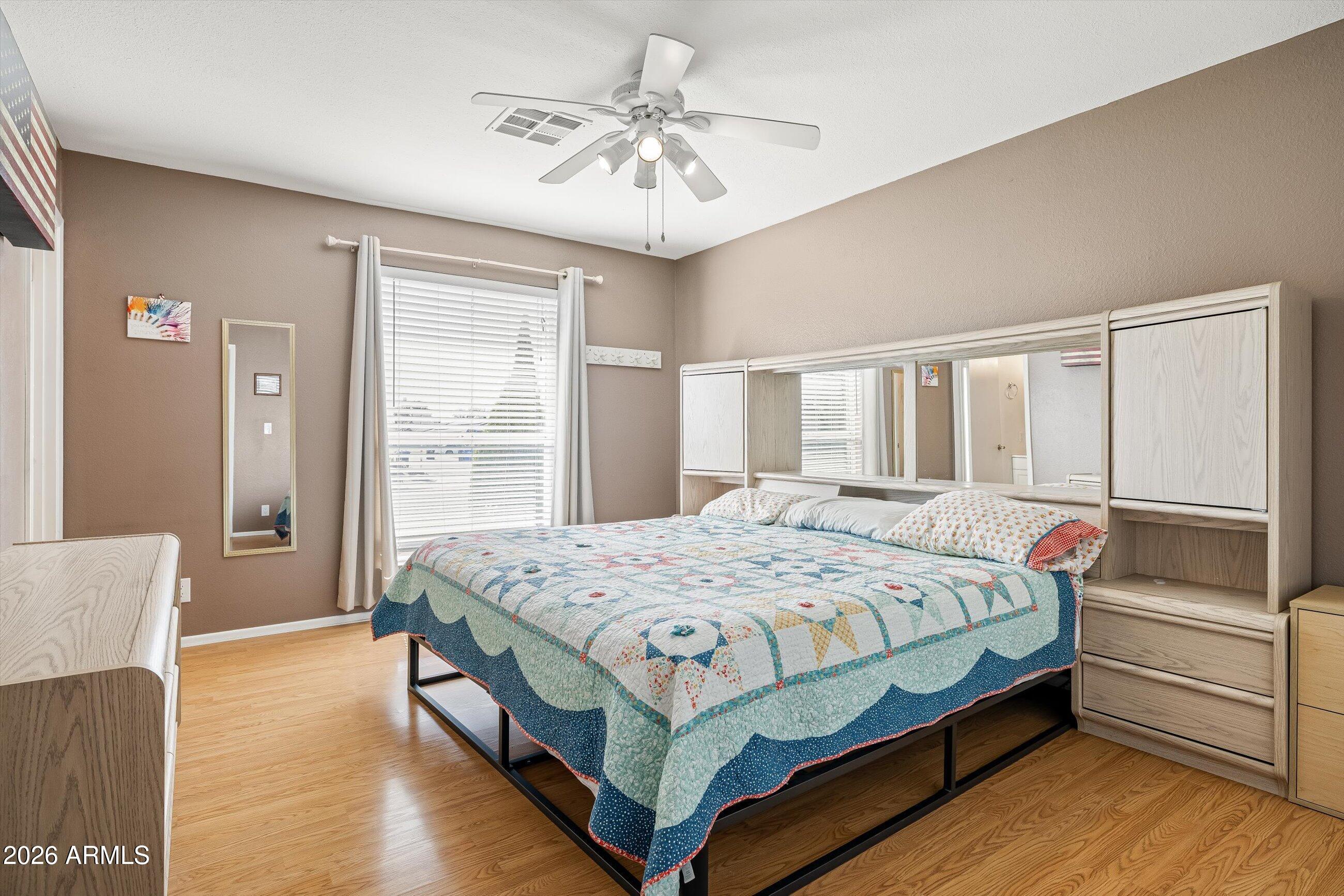 3024 West Wagoner Road Phoenix, AZ 85053 - Photo 11 of 34 a bedroom with a bed and a chandelier