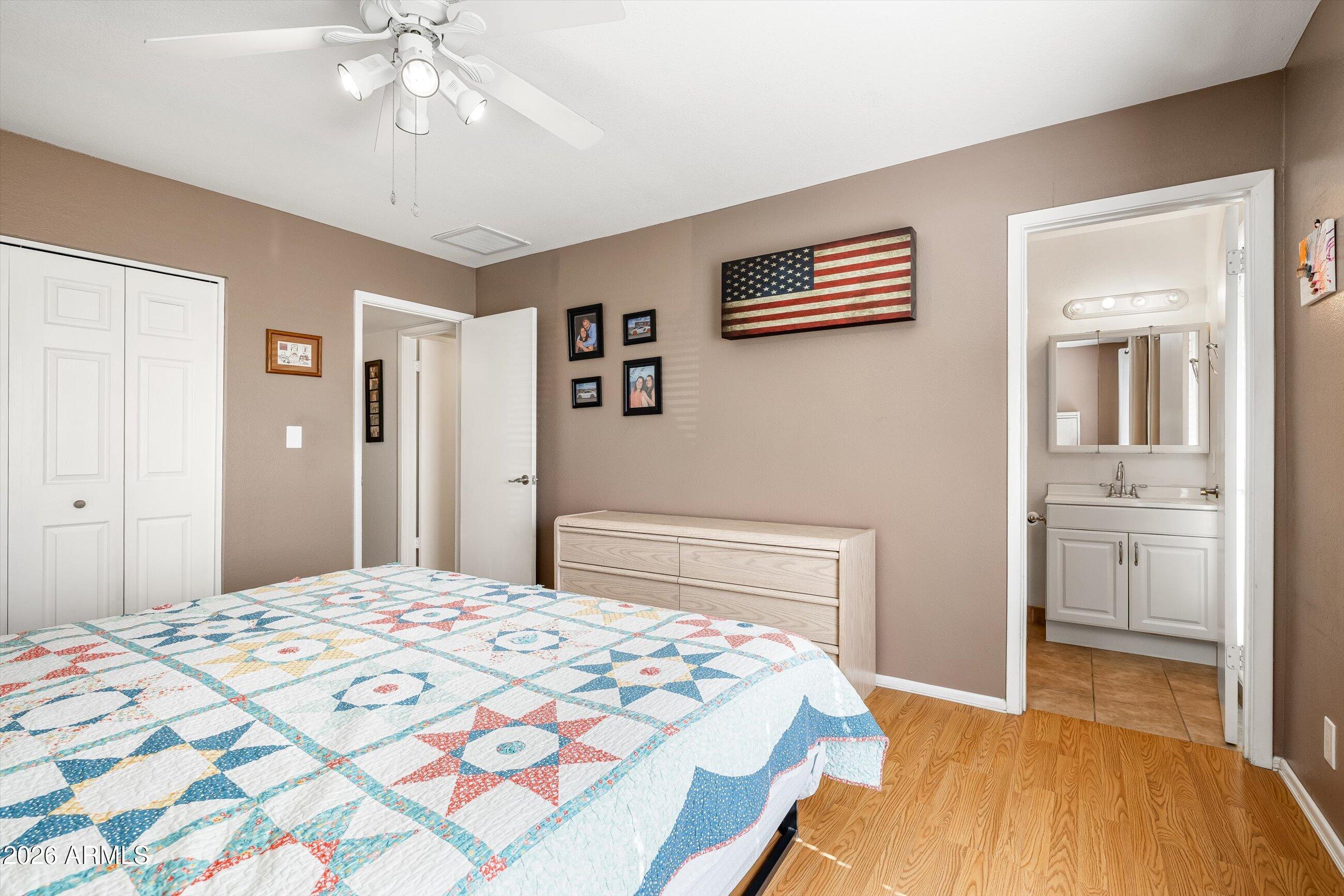 3024 West Wagoner Road Phoenix, AZ 85053 - Photo 12 of 34 a bedroom with a large bed and a chandelier