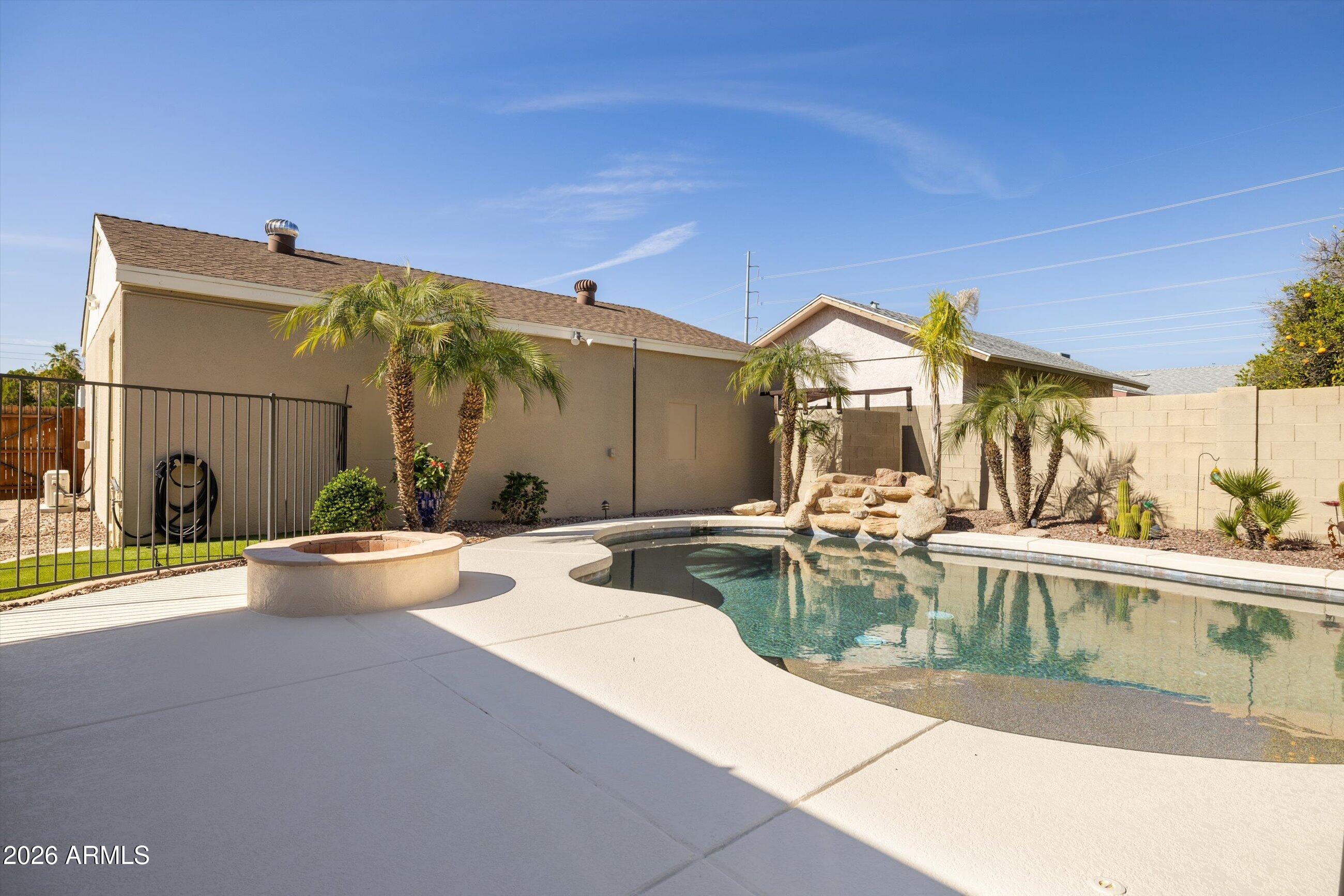 3024 West Wagoner Road Phoenix, AZ 85053 - Photo 19 of 34 a view of a swimming pool with a patio