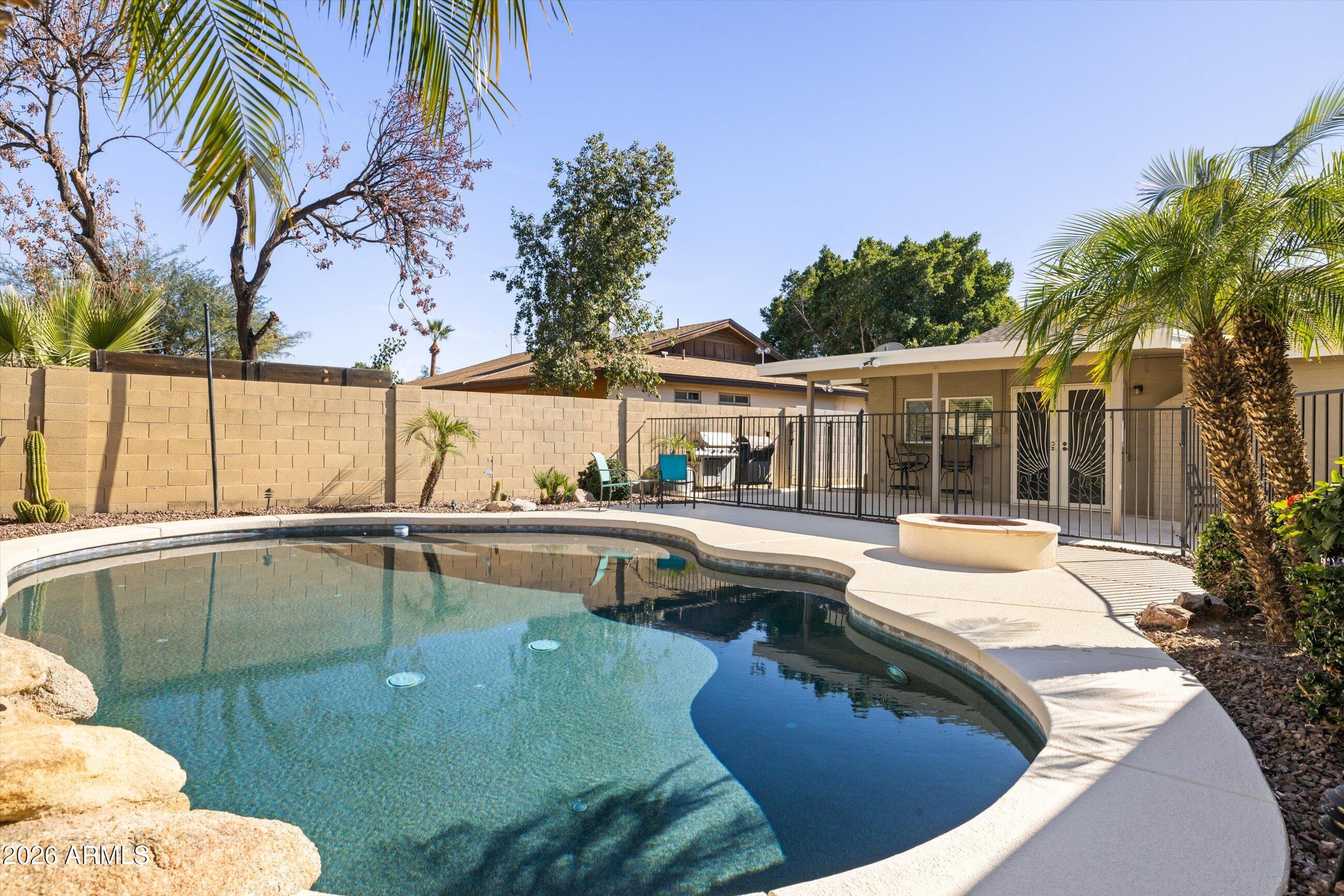 3024 West Wagoner Road Phoenix, AZ 85053 - Photo 21 of 34 a view of a swimming pool with a lounge chairs