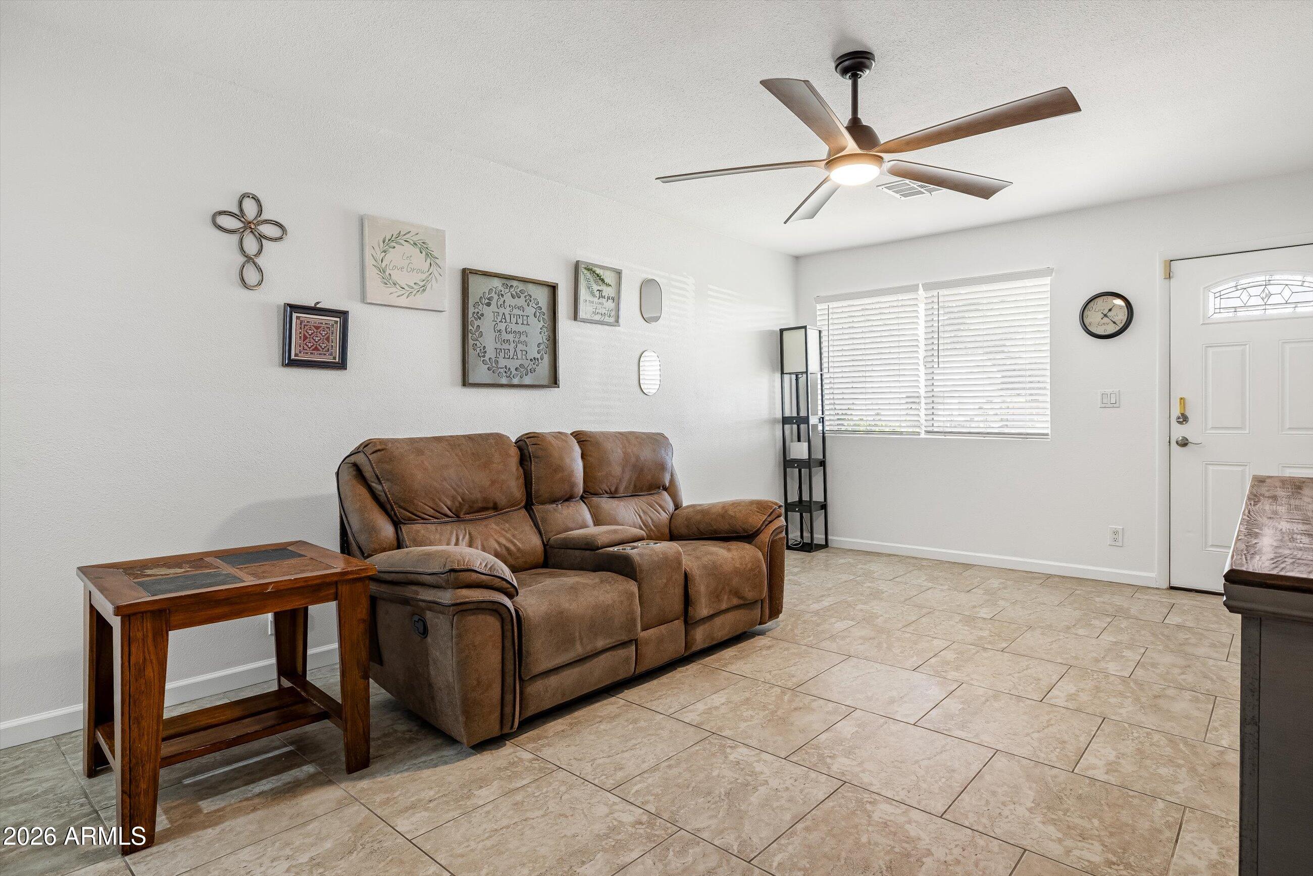 3024 West Wagoner Road Phoenix, AZ 85053 - Photo 4 of 34 a living room with furniture and a wooden floor