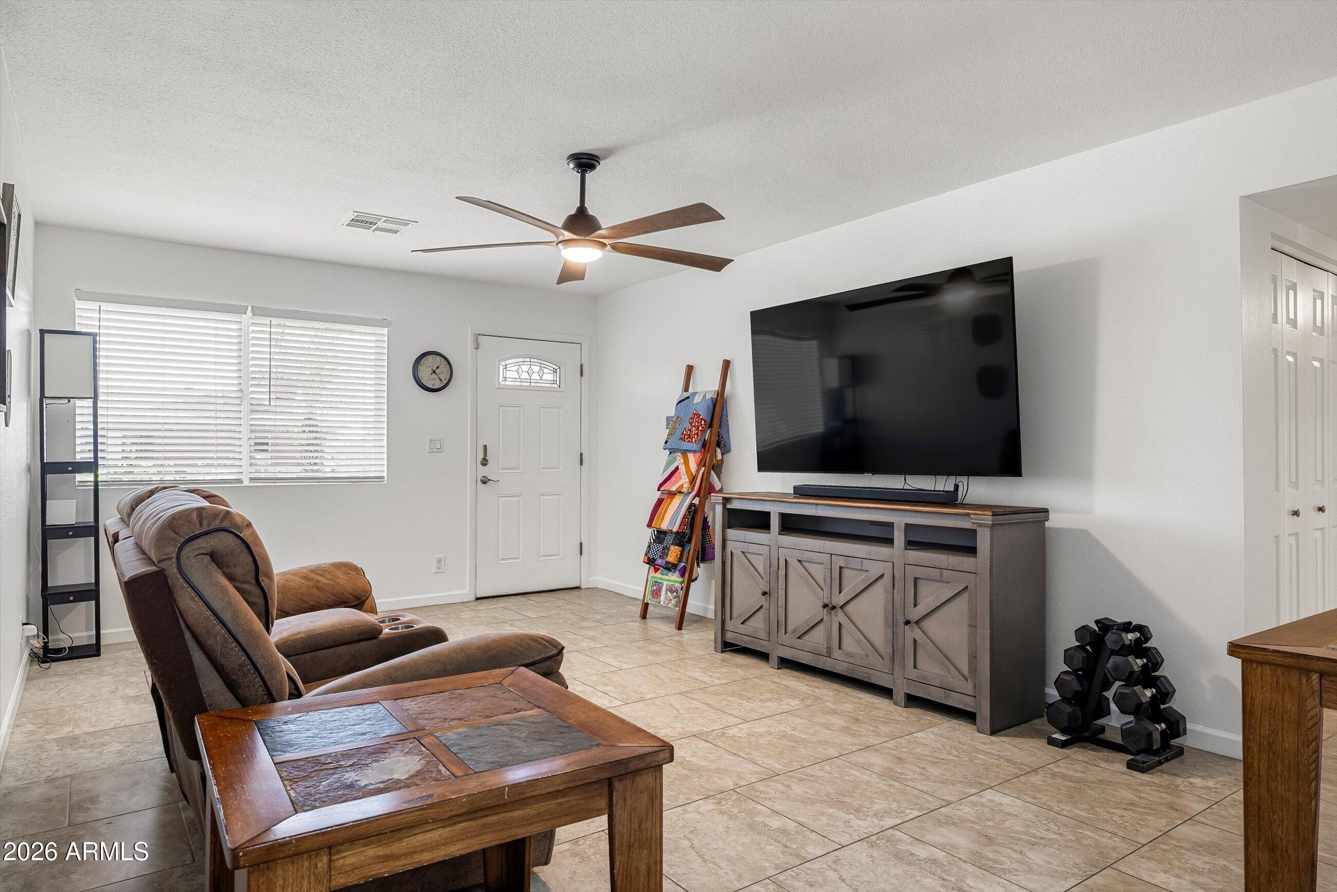 3024 West Wagoner Road Phoenix, AZ 85053 - Photo 5 of 34 a living room with furniture and a flat screen tv