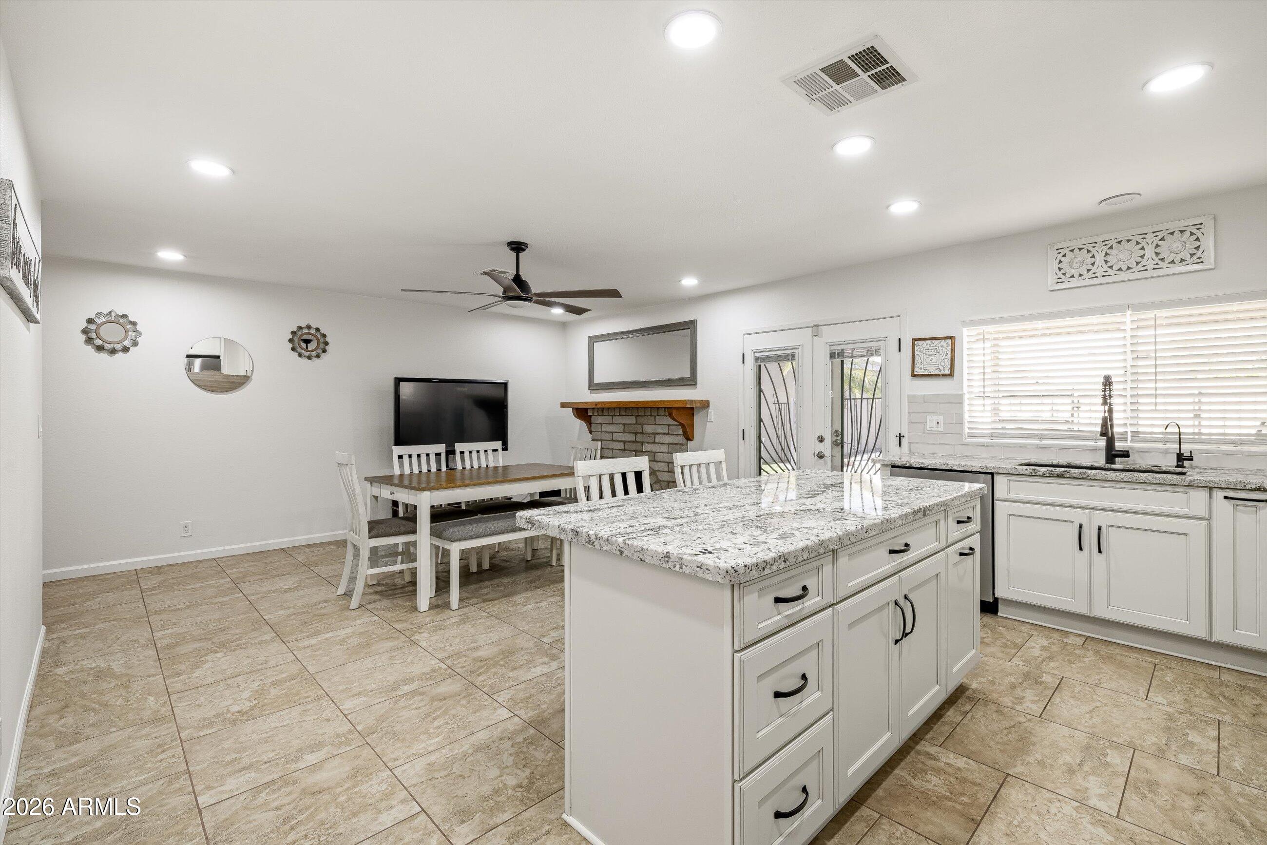 3024 West Wagoner Road Phoenix, AZ 85053 - Photo 7 of 34 a open kitchen with stainless steel appliances kitchen island granite countertop a sink and cabinets