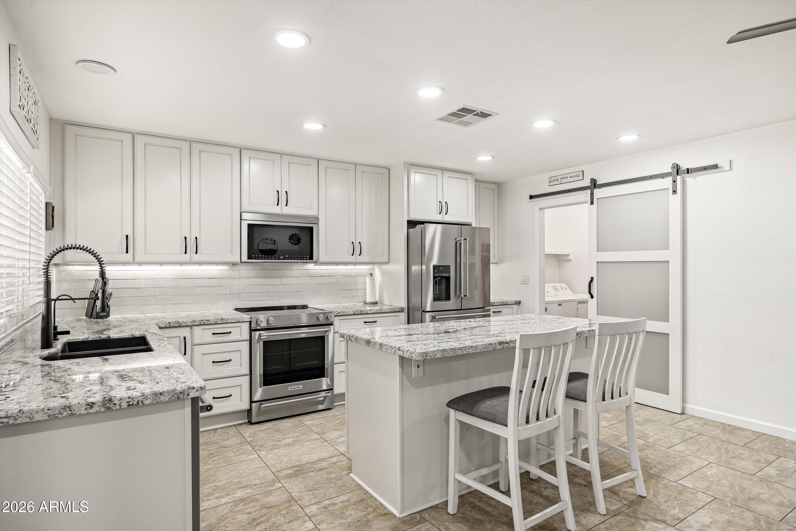 3024 West Wagoner Road Phoenix, AZ 85053 - Photo 10 of 34 a kitchen with appliances a sink and cabinets