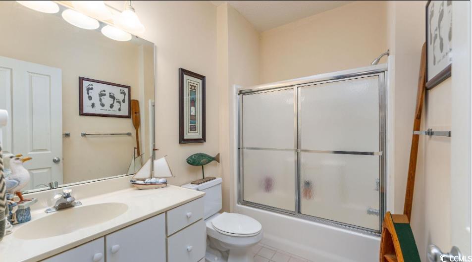 4603 Arran Court, Unit C Myrtle Beach, SC 29579 - Photo 17 of 34 Bathroom featuring bath / shower combo with glass door, toilet, and vanity