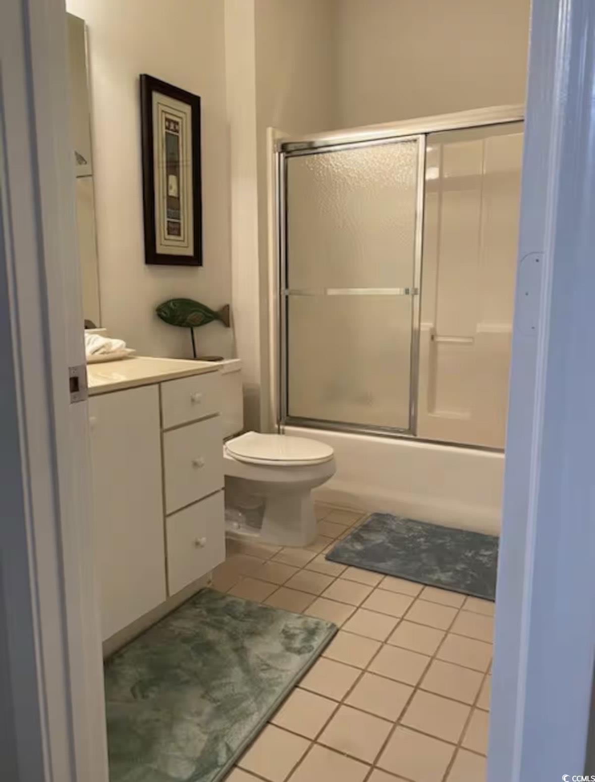 4603 Arran Court, Unit C Myrtle Beach, SC 29579 - Photo 19 of 34 Bathroom with tile patterned floors, vanity, shower / bath combination with glass door, and toilet