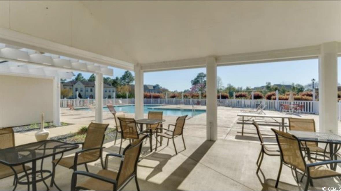4603 Arran Court, Unit C Myrtle Beach, SC 29579 - Photo 27 of 34 View of patio with a community pool, fence, and outdoor dining space