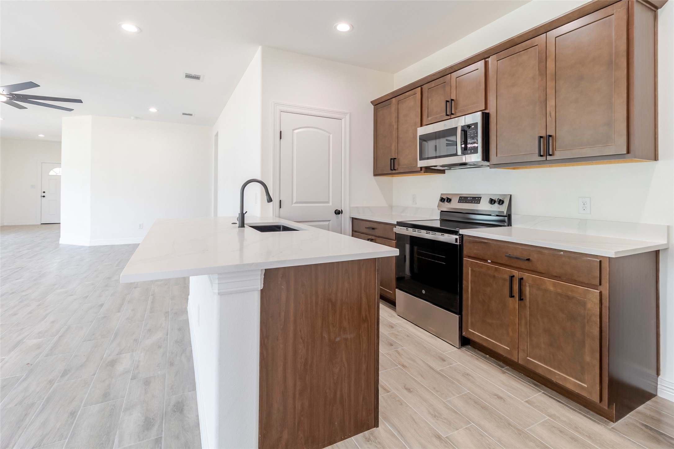 311 Myrtle Road Smithville, TX 78957 - Photo 6 of 16 The breakfast bar keeps the kitchen in the conversation while leaving a clear lane for cooking and prep.