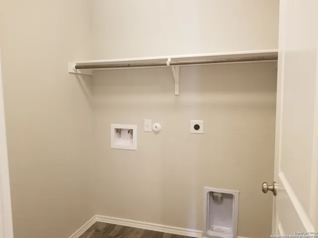 a kitchen with stainless steel appliances kitchen island granite countertop a stove top oven a sink and a refrigerator